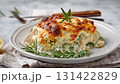 Creamy green bean casserole slice with chicken, cheese, and rosemary served on a plate with fresh green beans. Perfect for Thanksgiving, Christmas, or cozy holiday dinners 131422829