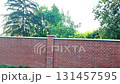 View of the newly completed red brick wall. New brick wall made of red bricks. Concept of construction and building work. 131457595