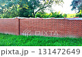 View of the newly completed red brick wall. New brick wall made of red bricks. Concept of building construction and construction site. 131472649
