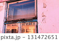View of the shabby facade of an old house. View of the old facade of the house, its windows and gates. Concept of estate agencies, reconstruction in the building sector. 131472651