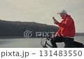 A man in a red jacket is talking on his cell phone 131483550