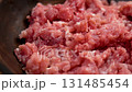 Raw ground pork in wooden bowl closeup. Fresh meat forcemeat. Rotation 131485454