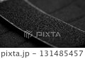 Black velcro tape texture. Fastening element. Macro. Rotation 131485457
