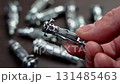 Anchor drywall fastener in the hand of a mechanic in a workshop close up. Industry tool concept 131485463