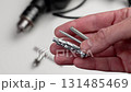 Selection of the type of fasteners in the workshop. Bolt, anchor and screw in the repairman hand close up 131485469