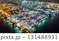 Aerial view hyperlapse container cargo ship international port terminal with gantry crane at night, Industrial cargo container port loading and unloading, Global business logistic import export. 131488931