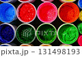 A collection of plastisol inks stored in sturdy barrels and glass jars, each filled with rich and vibrant colors red, blue, yellow, green, pink, orange, purple, and white in screen printing factory 131498193