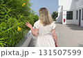 A woman is truly enjoying the beauty of nature surrounded by vibrant, bright yellow flowers 131507599