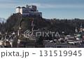 Aerial view of Salzburg, Austria, showing the Salzach River, Salzburg Cathedral, Hohensalzburg Fortress, bridges, and distant snow capped mountains. 131519945