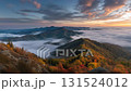 A dawn scene of mountains colored in autumn leaves and a sea of clouds 131524012