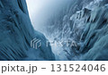 A scene of severe winter with countless icicles hanging from the cliffs of a snow-covered valley 131524046