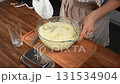 Woman using mixer to whip potatoes for mashed potatoes. Close-up, creamy. 131534904