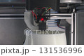 The printer is printing a plastic product. 131536996