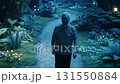 A man strolls leisurely through a fabulous natural landscape illuminated by moonlight. 131550884