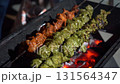 spicy kebab sizzling over red-hot coals 131564347