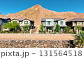 Aerial Suburban Homes Nevada Desert Mountain Tracking Shot with Palm Trees 131564518