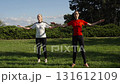Group fitness activity in a sunny outdoor park 131612109