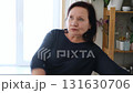 Senior woman dance at home. Elderly lady listening song and moving. Old female brunette feels calmly, relish carefree retired life looks happy. Vitality, wellness. Grandmother dancing alone indoors. 131630706