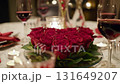 Romantic dinner table setting with heart shaped red roses centerpiece and wine glasses 131649207
