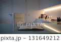 Modern office desk with open notebook as lights dim, creating a quiet, reflective atmosphere 131649212