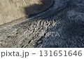 Aerial view of a rugged glacier in Pakistan, highlighting the stark contrast between ice and surrounding mountains 131651646