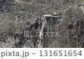 Aerial view of a remote village nestled in the mountains of Pakistan, showcasing traditional architecture and a majestic rock formation 131651654