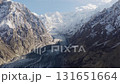 Aerial view of a majestic glacier nestled between towering snow-peaked mountains in Pakistan 131651664