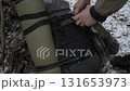 Preparing camping gear for winter adventure in a snowy forest setting 131653973