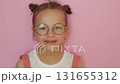 A sweet, beautiful, cheerful girl takes off her round-rimmed Eyeglasses and enjoys her good eyesight 131655312