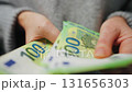 Woman counting euro bills, close-up 131656303