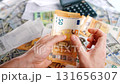 Man calculating money, monthly home expenses, taxes and bank account balance. 131656307