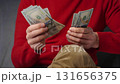 Man counting US Dollar bills, close-up 131656375