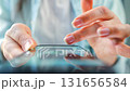 Woman scrolling through social media feeds on smartphone close up 131656584