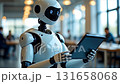 Humanoid robot interacts with digital tablet in modern office environment during afternoon 131658068