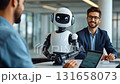 A business professional in a suit sits at a desk across from a humanoid robot, both smiling and engaged in a lively discussion. The modern office environment enhances the interaction. 131658073
