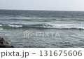 Serene Ocean Waves Gently Crashing upon Rugged Rocky Shoreline with Scenic Beauty 131675606