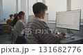 Male Student Learning Programming at Computer in Bright Classroom 131682776