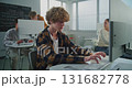 Curly Haired Young Man Working on Game Development Project 131682778