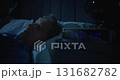 Middle Aged Man in Pajamas Lying in Bed at two AM, Scrolling Smartphone 131682782