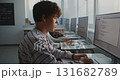 Serious Student Working With Code on Monitor During Class 131682789