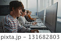 Close Up of Student in Striped Shirt Concentrating on Writing Code 131682803