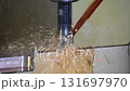 Slow motion scene the CNC milling machine rough cutting the mold parts with oil coolant method. The mold and die manufacturing process by CNC machining center. 131697970
