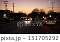 Walking along the central street of a city during sunset. 131705292