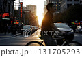 Walking along the central street of a city during sunset. 131705293
