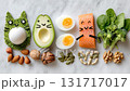 Creative food arrangement showcasing healthy ingredients with playful faces on a marble countertop 131717017