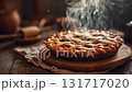 Freshly baked apple pie on a wooden table with steam rising in a cozy kitchen setting 131717020
