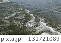 Captivating slow motion waves washing over the shore at sunset during a serene coastal experience 131721089