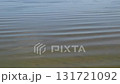 Rippling water patterns captured in slow motion at a tranquil lake during midday 131721092
