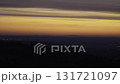 Stunning dawn over the hills with vibrant colors and distant city lights captured in time lapse near the mountains 131721097