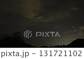 Capturing stunning timelapse of nighttime clouds and landscape with mountain silhouette at dusk 131721102